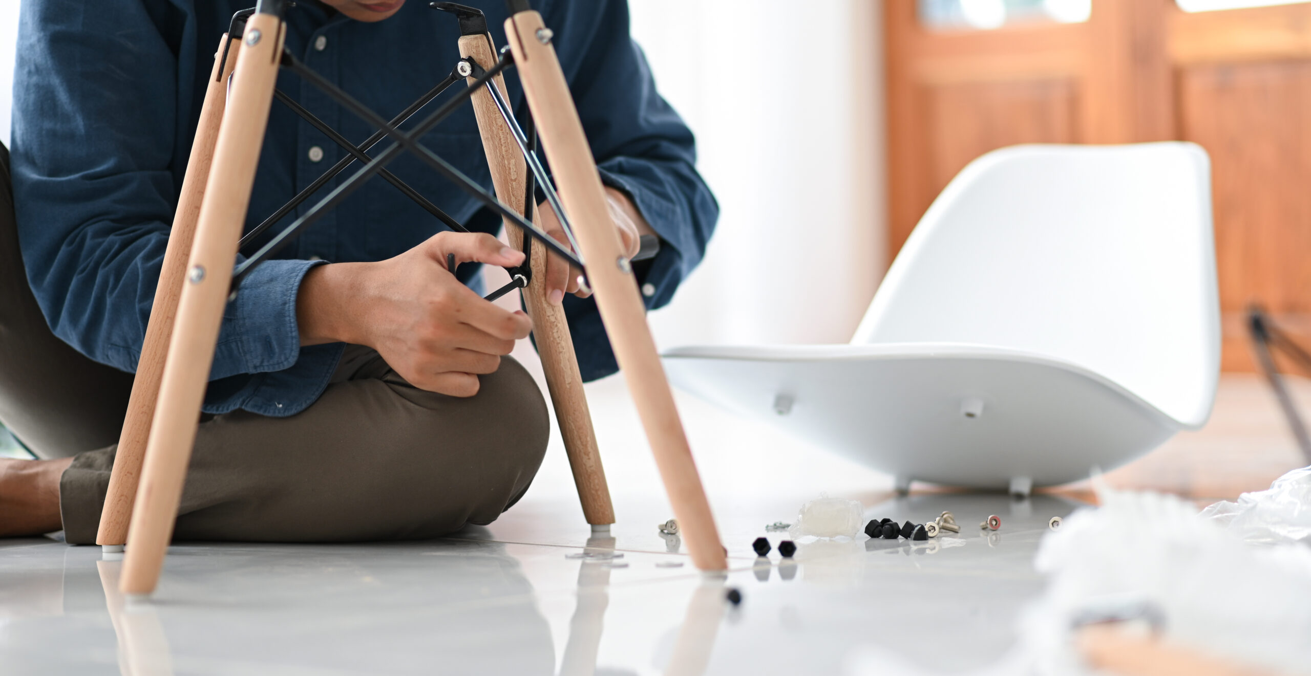 A young man assembling a chair in the house, D.I.Y Repair the ch