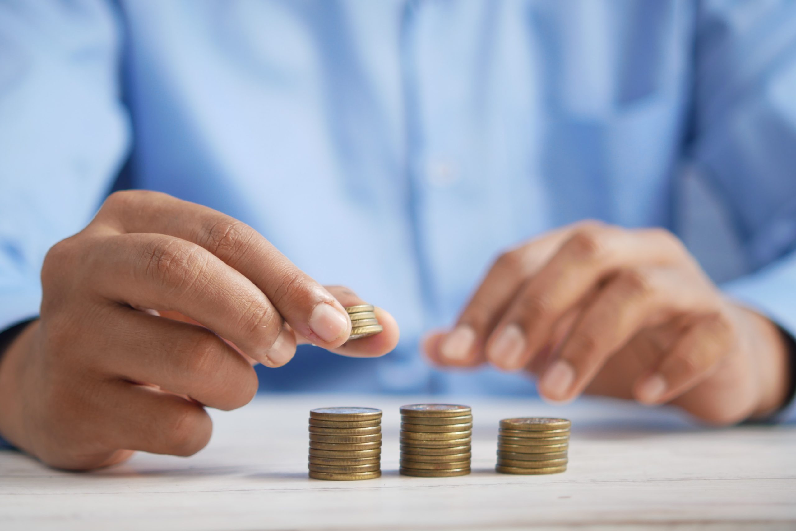 a close-up of hands holding coins